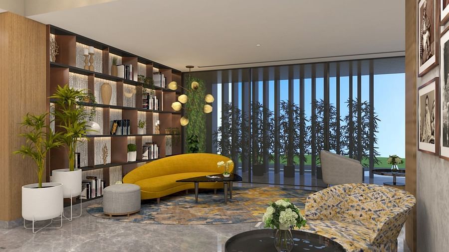 Sofa next to a showcase with books and vases - Golden Tulip Bhopal