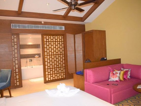 An image of a living area with a sofa and a wooden wardrobe.