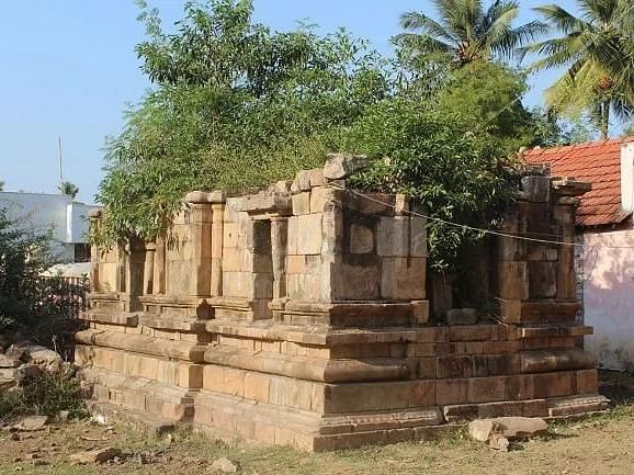 Cholanmaaligai Ruins of an ancient stone temple, with remnants of detailed carvings and structures.