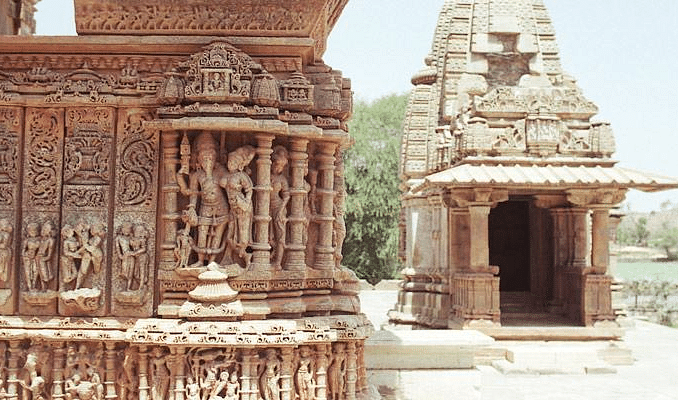 A close-up of intricately carved temple walls with figures and patterns. 