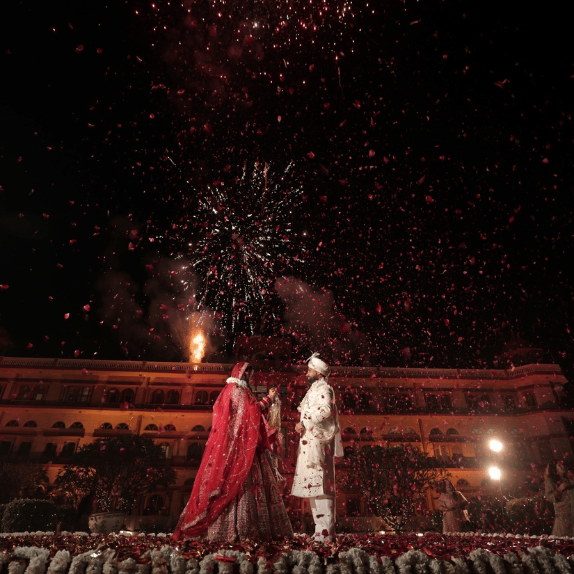 Advait & Akshay under a sky full of fireworks during their wedding night at Umaid Palace.
