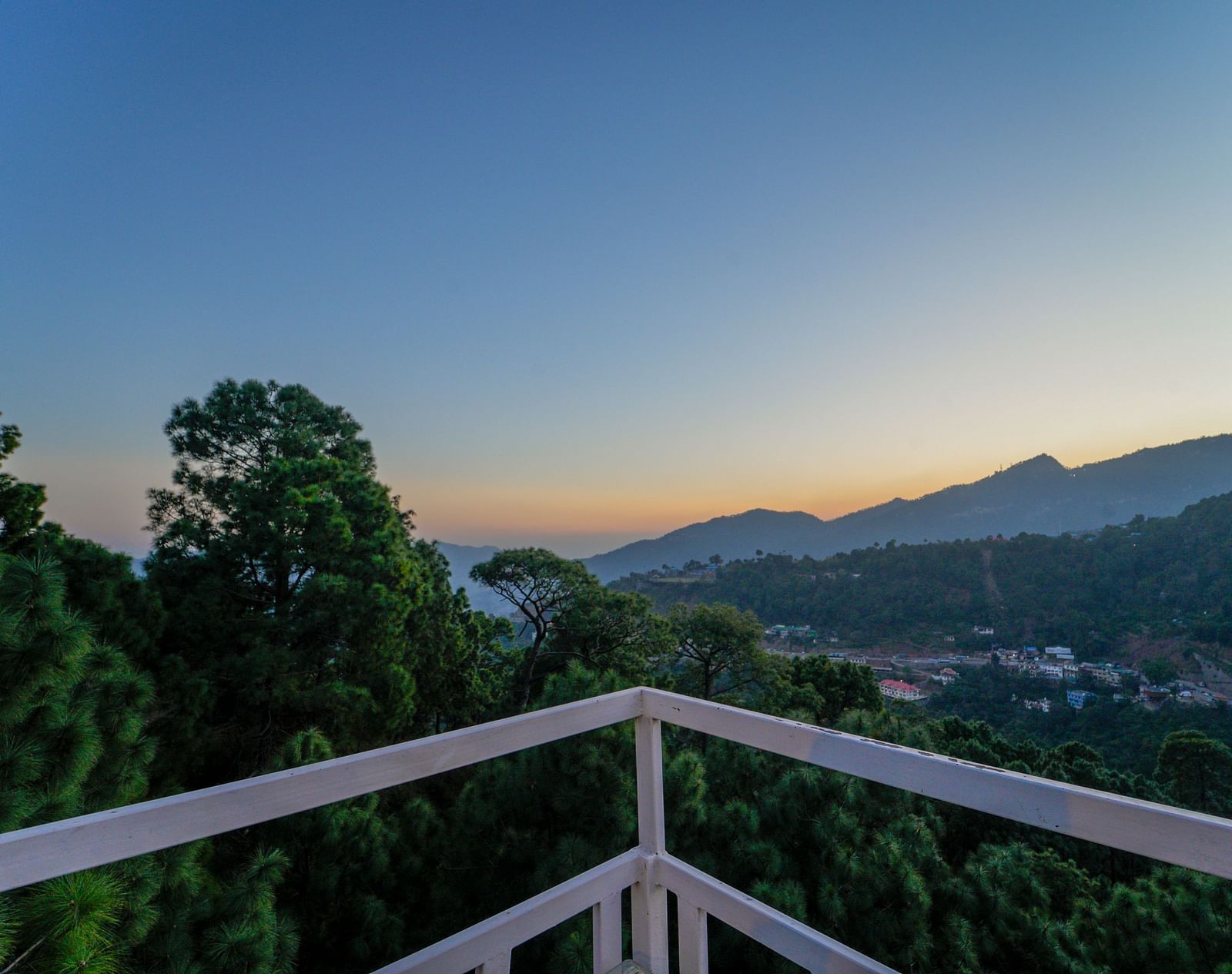 An overview of the open terrace at our Nature Resort Kasauli - DLS Whispering Winds, Kasauli, showcasing lush greenery around.