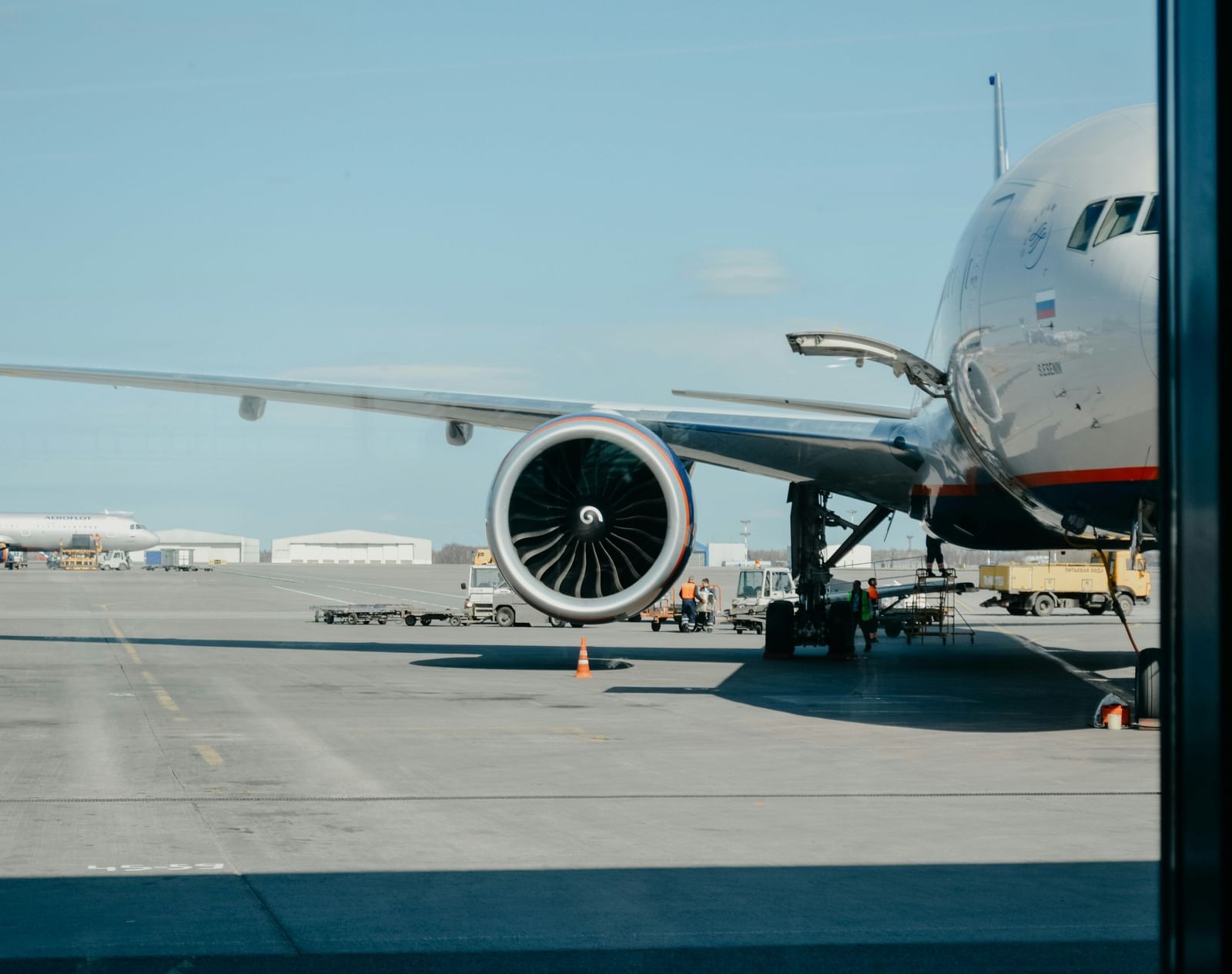 Shot of an aeroplane on the tarmac with a backdrop of clear sky.