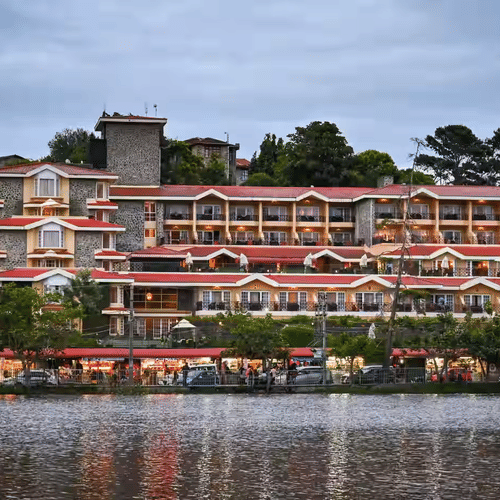 Facade view of The Carlton during day time as seen from across the kodaikanal river.