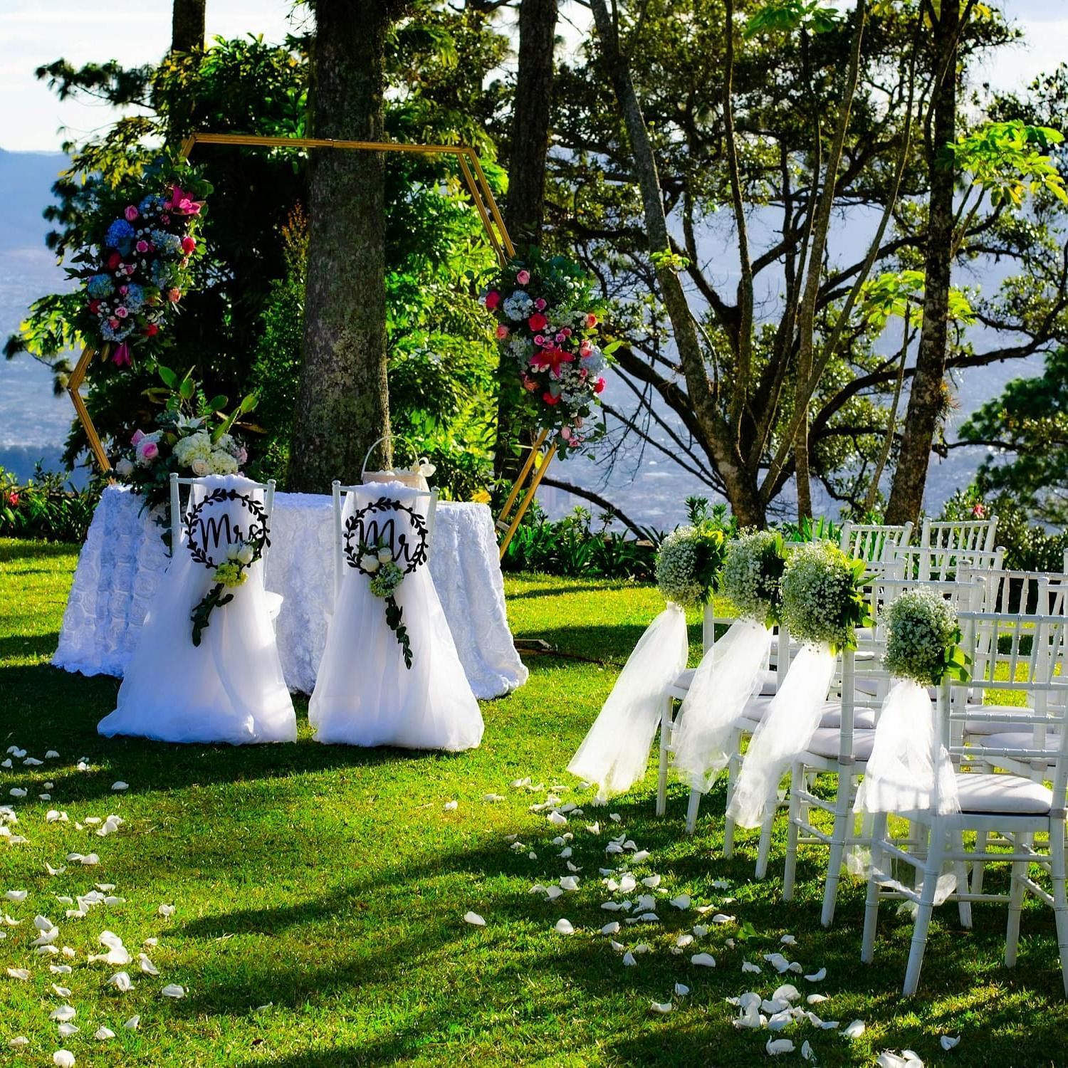 Image of an event venue with chairs and a pulpit area decorated with flowers at Aanandam Resort & Spa, Pushkar.