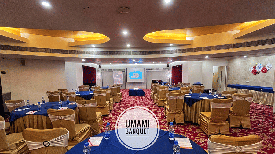 Full view shot of Ummami Banquet Hall with a patterned carpet flooring and a false ceiling above - Senses Hotel