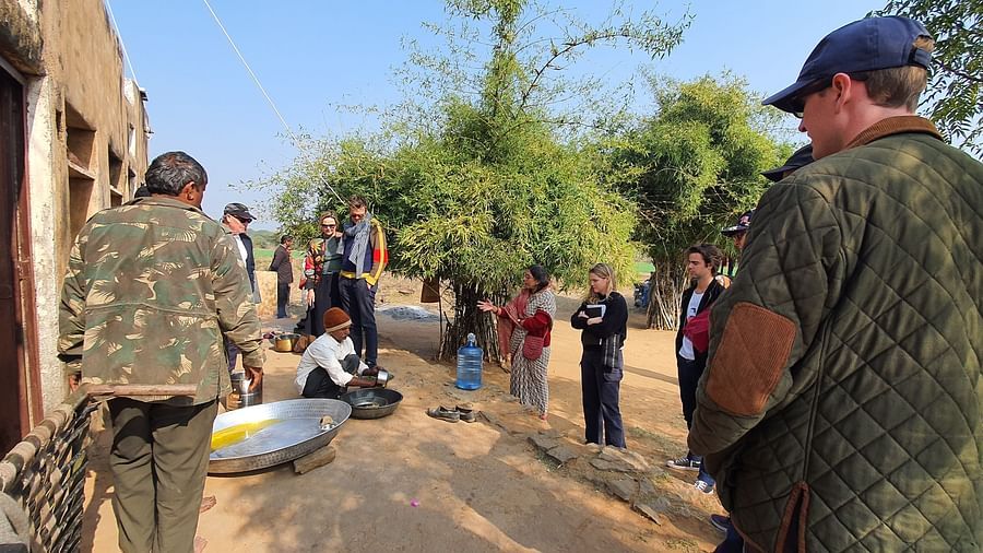 image of a group of tourists visiting a local school at dev shree, deogarh