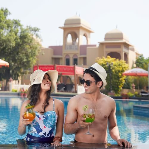 two people in front of a cool with beverages 