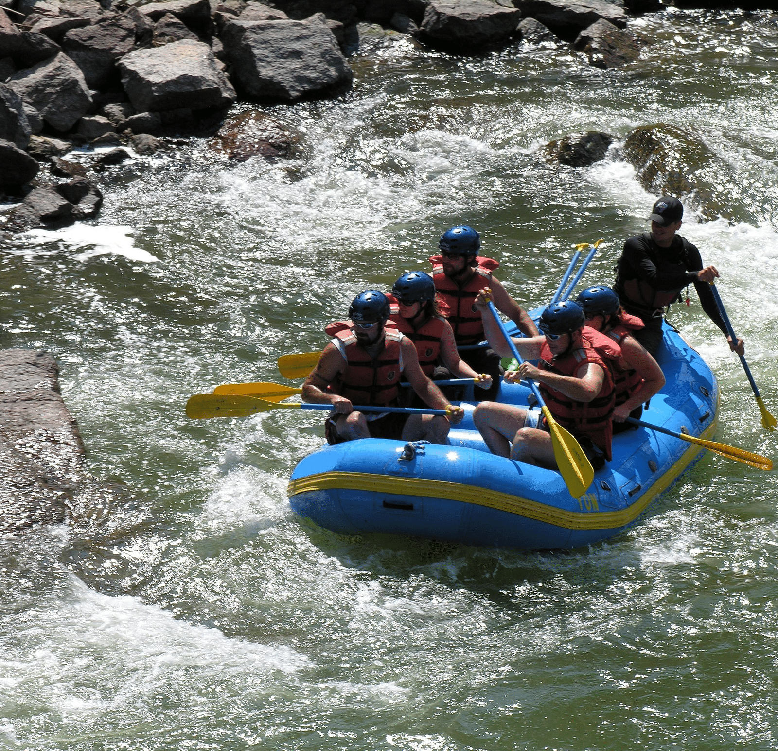 An image of a group of people rafting on a river