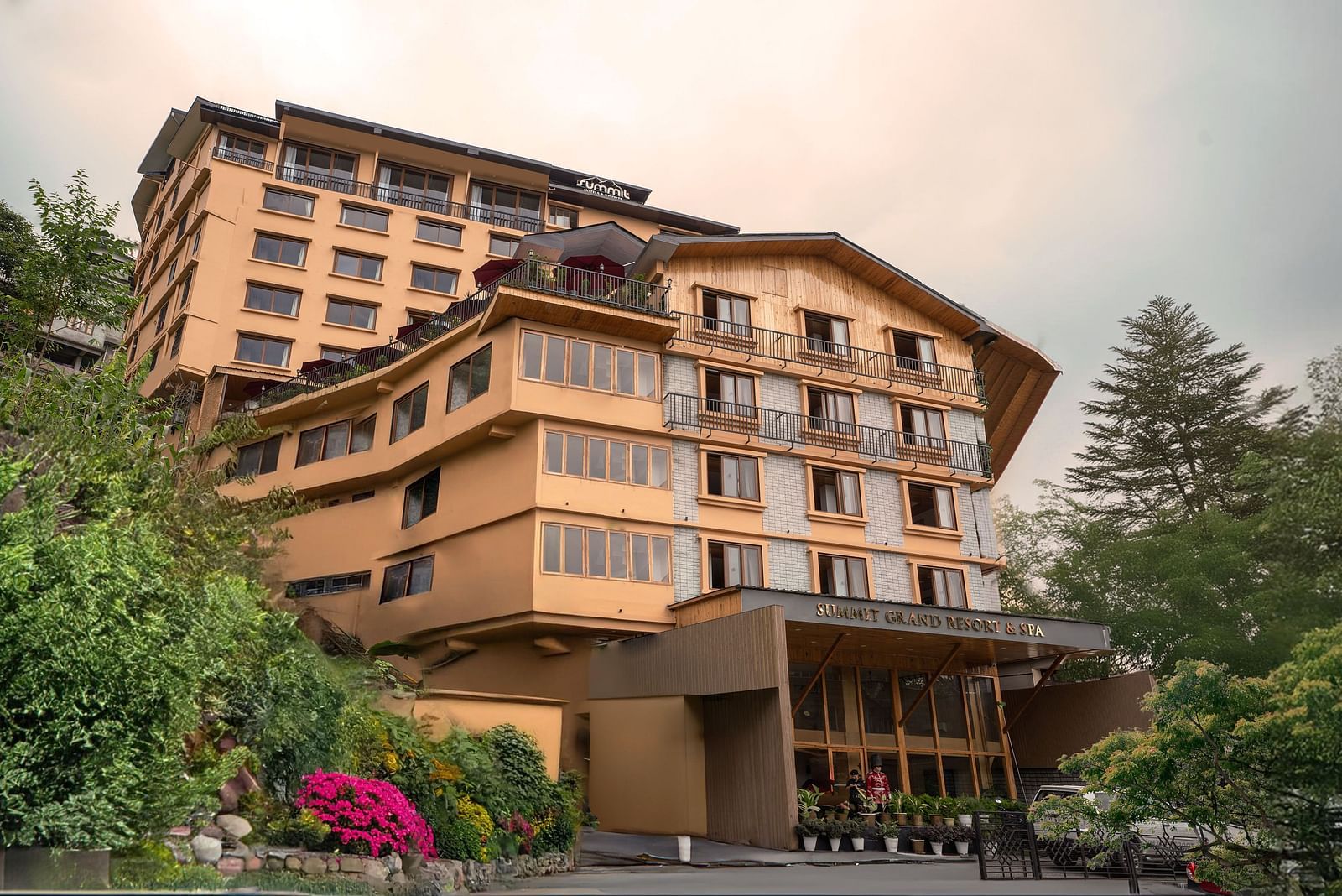 Facade image of Summit Grand Resort & Spa, Gangtok, with trees lining the pathway