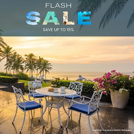 Flash sale promotional banner for MAYFAIR Palm Beach Resort, Gopalpur, featuring a beachside dining setup with a sunset view