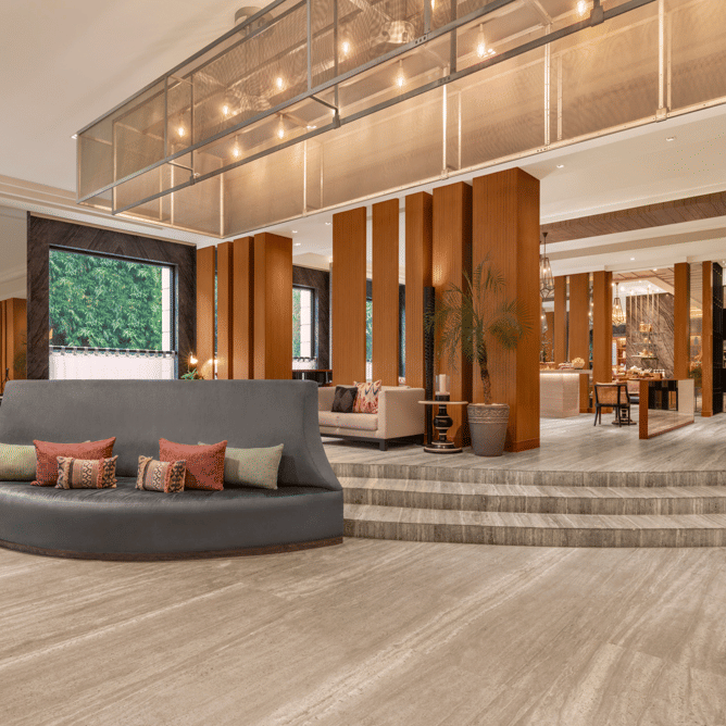 Lobby with seating area, reception desk, and ceiling lights at The Raintree, St. Mary’s Road.