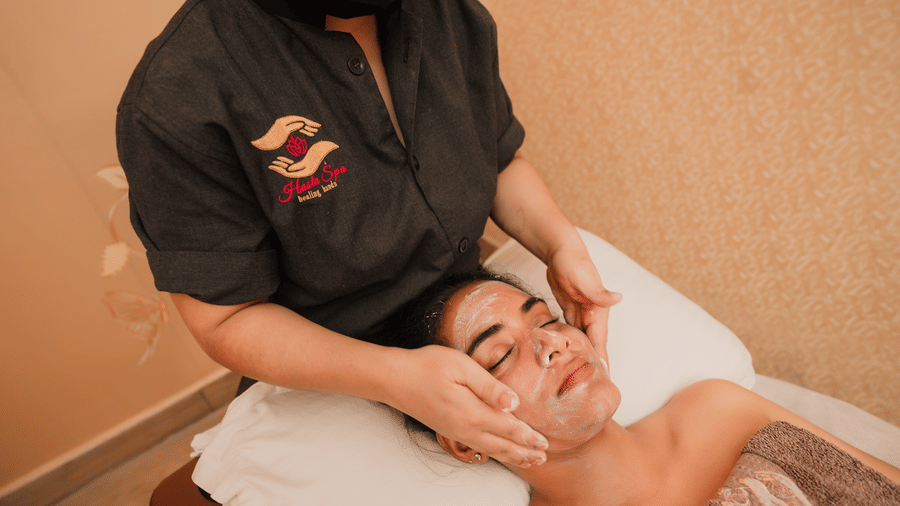 Close view of a facial treatment with cream being massaged into a guest's cheeks at Hasta Spa, the wellness spa at Ilara Hotels & Spa, Tada.