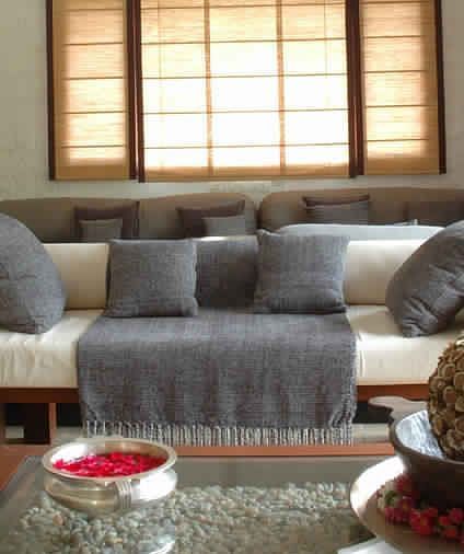 A living room with a gray couch, a wooden table - Shreyas Retreat
