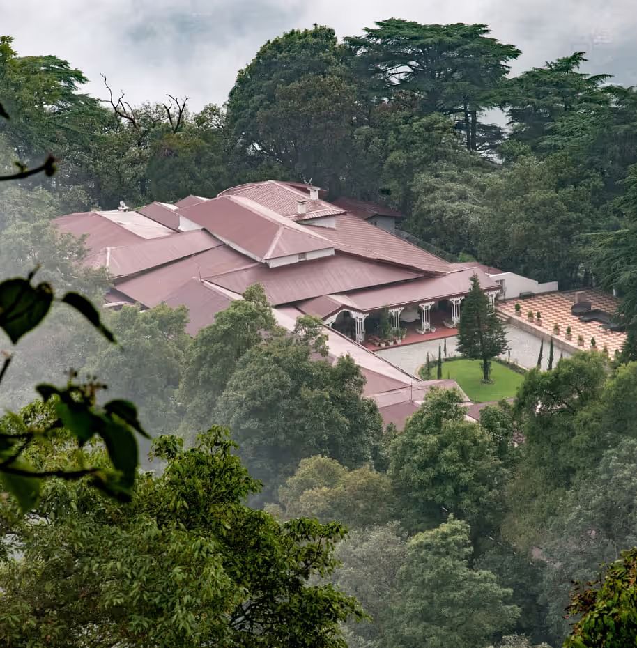 aerial view shot of The Claridges Nabha Residence in Mussoorie surrounded by lush green forest