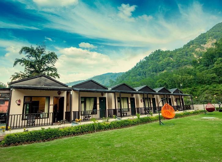 Lush garden views in front of the accommodations at DLS MJ River Resort, Rishikesh.