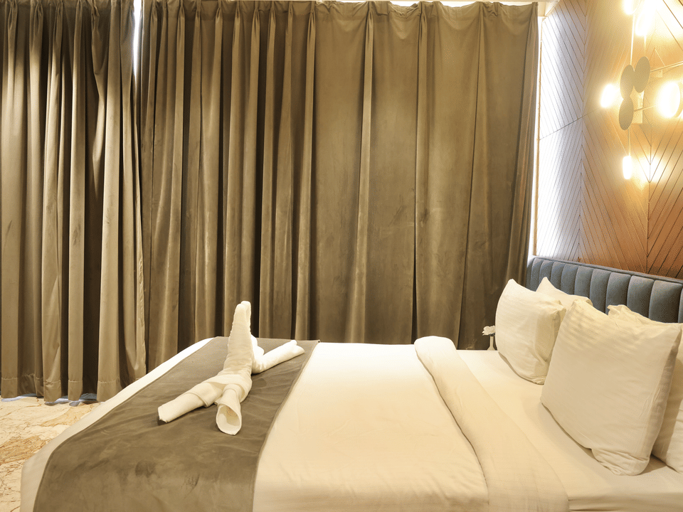 Skyline by Miraya, Venus Family Room, Turned-down bed with garden drapes