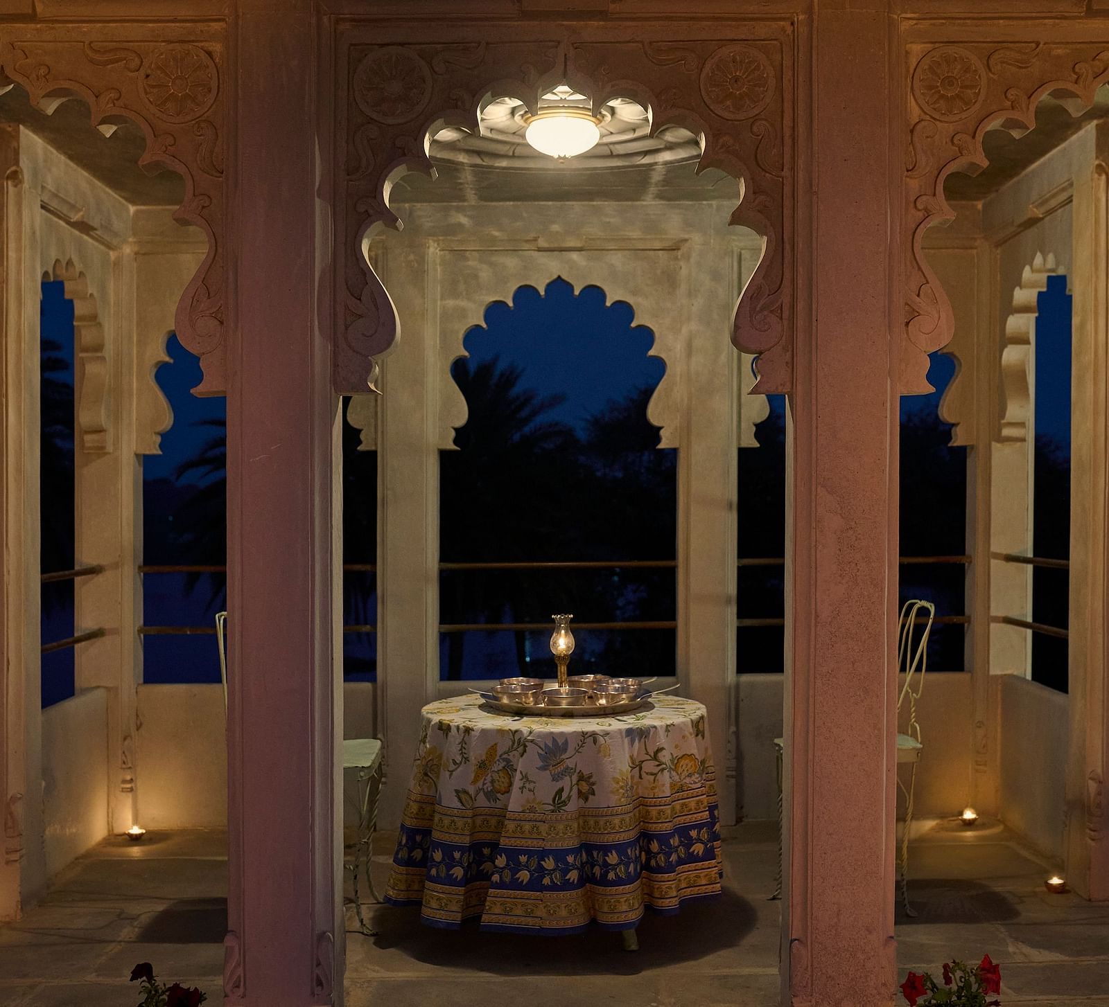 image of a balcony with arched pillars featuring a round table in the middle at Dev Shree, Deogarh