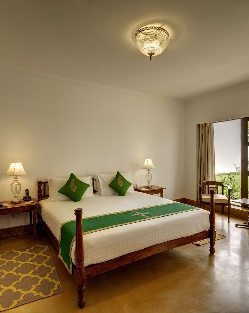 Residency Room with a double bed and a work desk and chair at Saraca Hotel, Lucknow