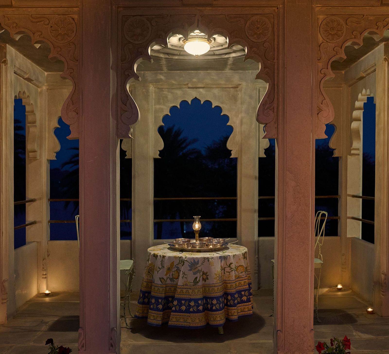 image of a balcony with arched pillars featuring a round table in the middle at Dev Shree, Deogarh