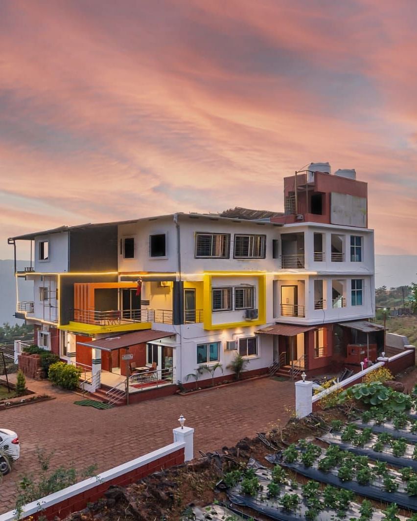 An exterior view of Strawberry King Resort, Mahabaleshwar at dusk.