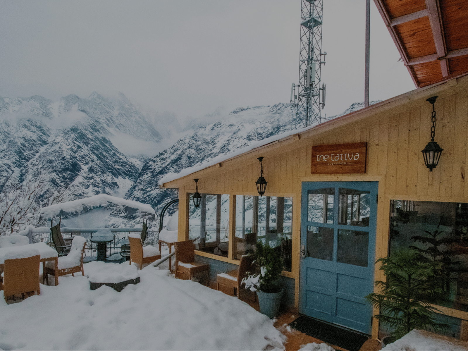 A wooden cabin amidst the snow capped mountains of Joshimath.