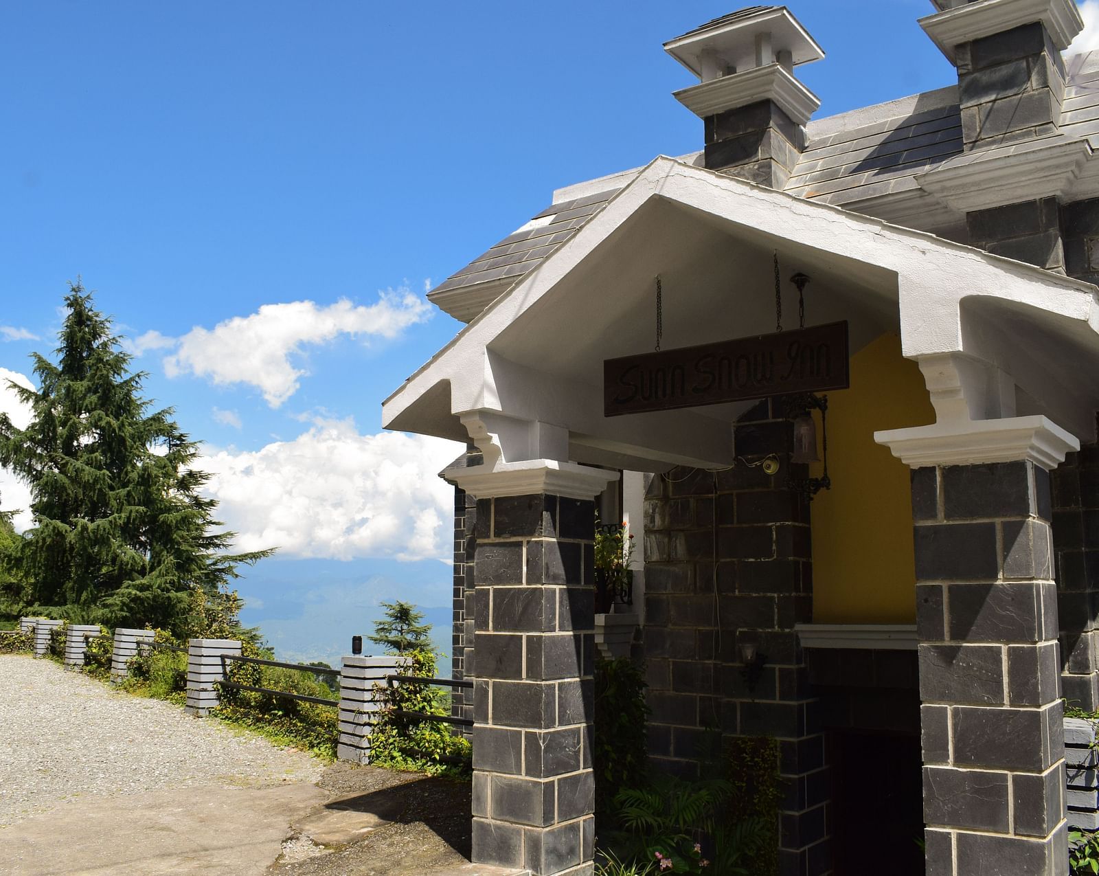 A front view of the facade of a hotel in Kausani - Sun N Snow Inn, Kausani