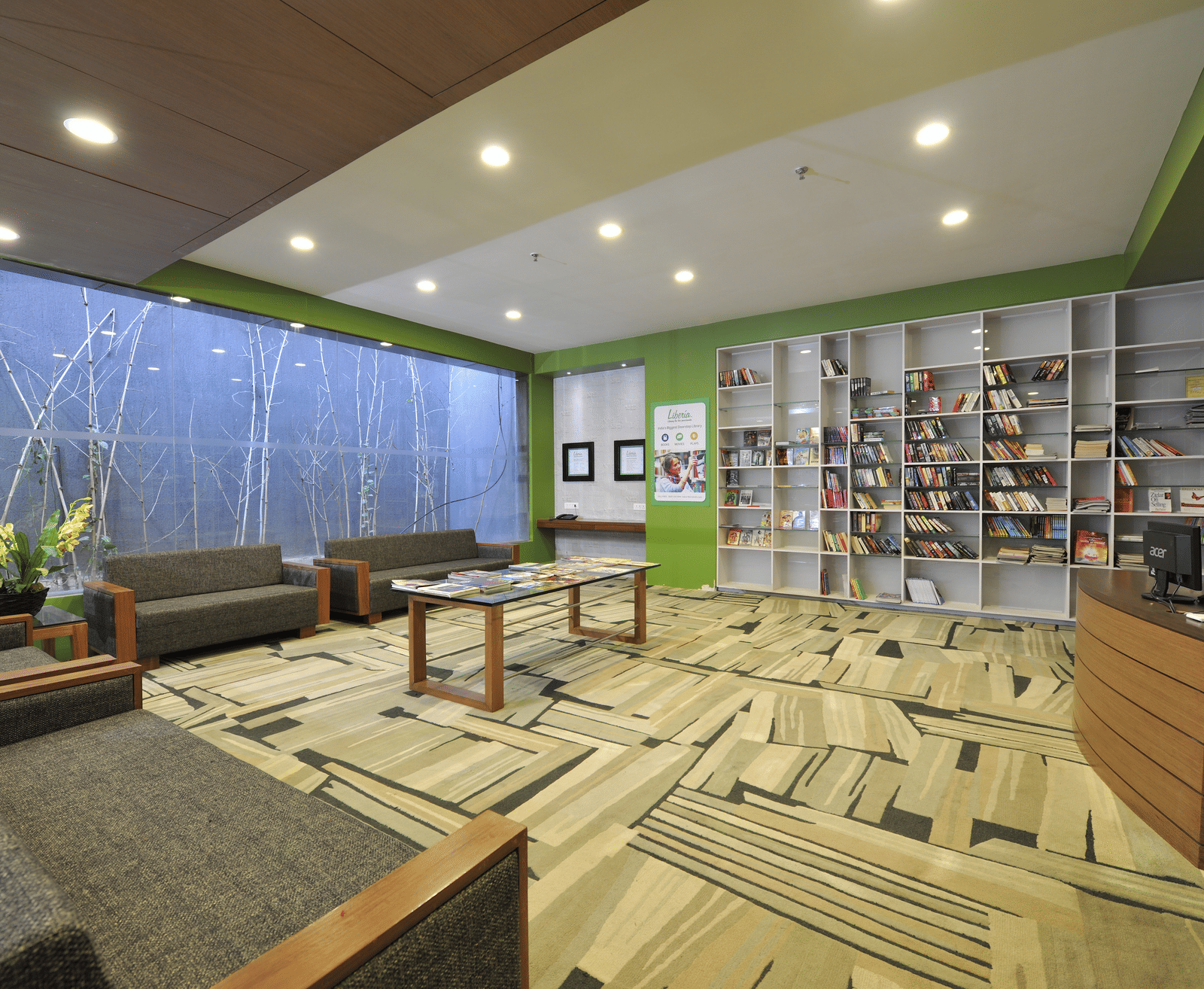 Spacious lounge area with plush seating and a large bookshelf – Narayani Heights Hotel & Resorts