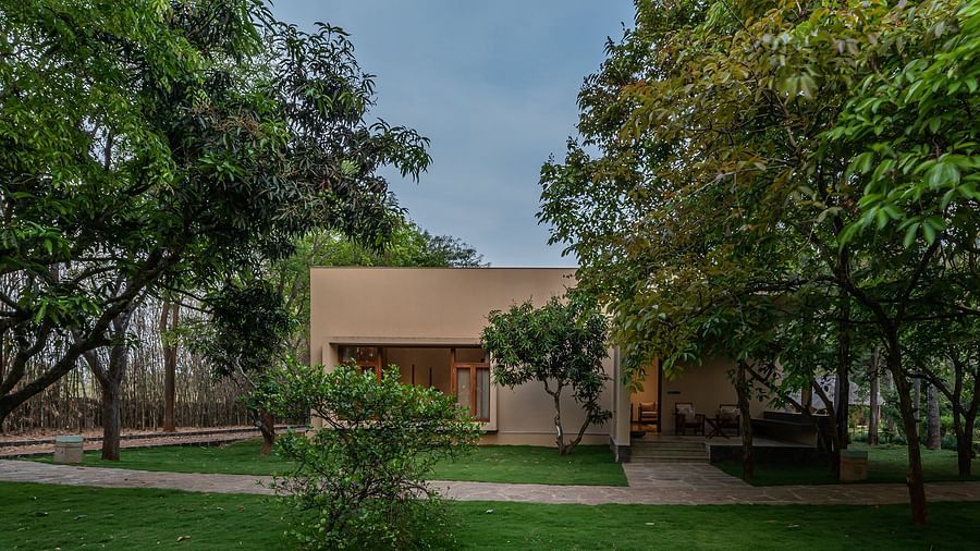 Garden with trees and a building in the background, outdoor landscape, natural setting - Shreyas Retreat