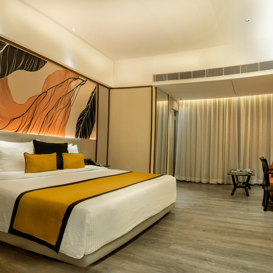 Stylish bedroom featuring plush bedding, contemporary art and refined interiors at The Sonnet, Jamshedpur.