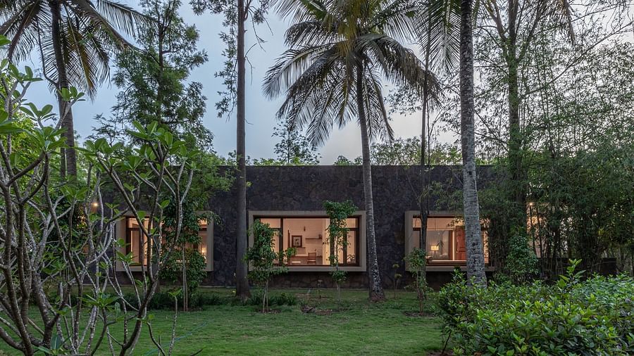 Exterior of a building with trees and plants, outdoor landscape, natural setting - Shreyas Retreat