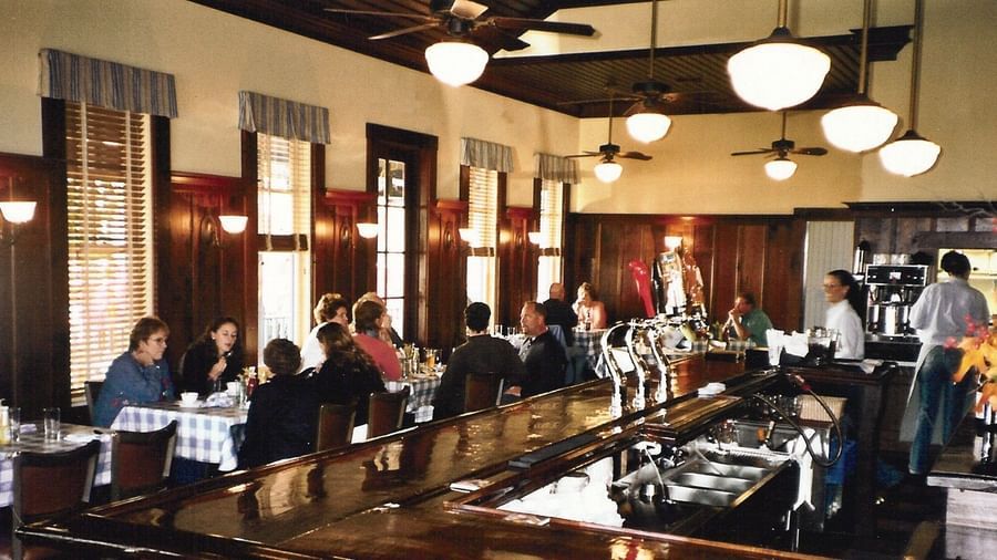 Guests enjoy drinks and conversation at the lively bar and dining area within the Tallman Hotel.