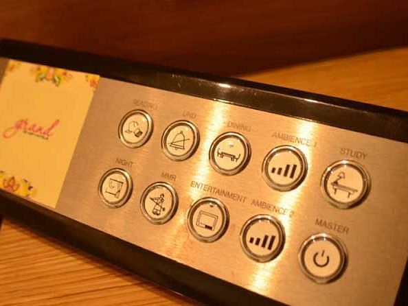 An image of a room lighting controller featuring multiple options for adjusting brightness, colour, and mood settings.