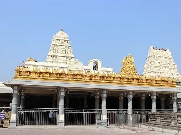 An image of a temple structure with the backdrop of a clear blue sky