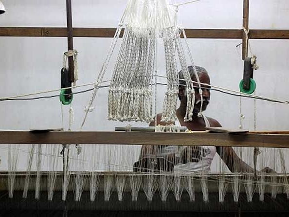 An image of a man using a weaving machine
