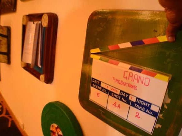 An image of a clapper-board and other wall hangings hung on the wall