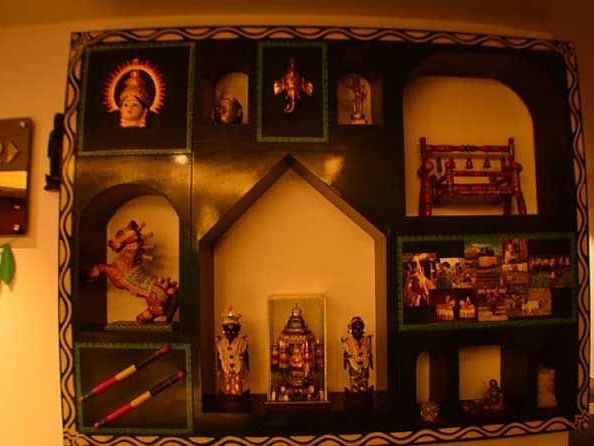 A close up shot of a wall mounted art frame with different sculptures made on it