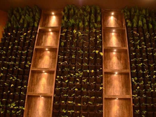 An image of flower pots mounted on either side of two pillars