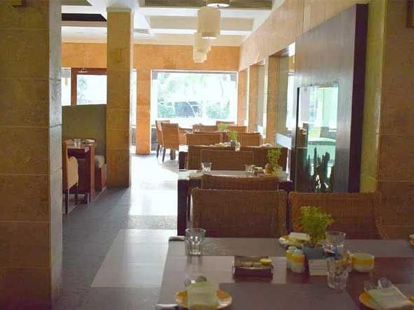 An image of a dining space with tables and chairs.