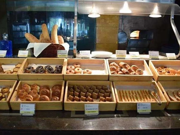 An image showcasing an assortment of desserts and bakery items neatly displayed.
