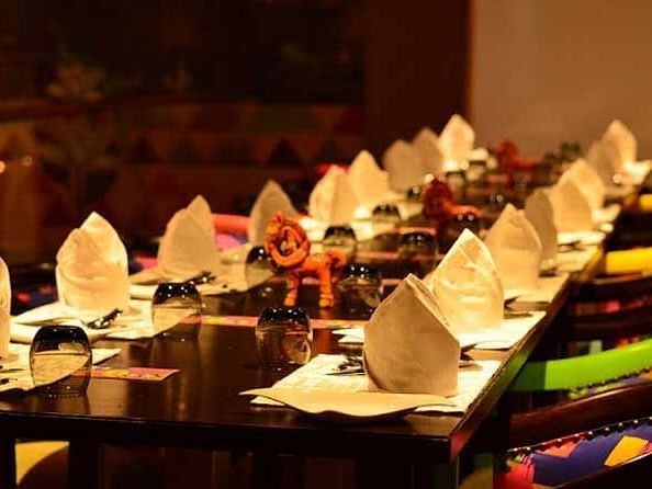 An image from a different angle of the restaurant featuring cutlery and crockery laid out on the table