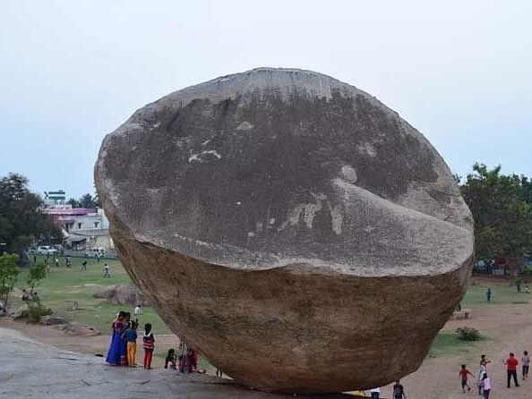 A large stone standing upright without any visible support or balance.