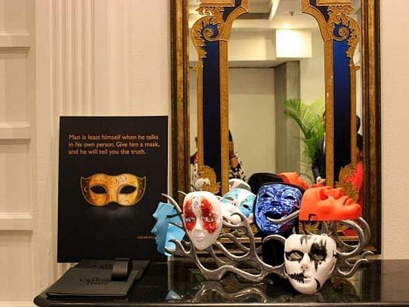An image of different face masks placed in front of a mirror