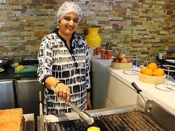 An image of a woman cooking in a kitchen