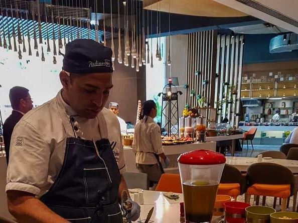 A chef assembling food at one of the buffet tables.