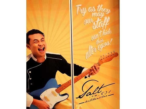 An image of a poster of a man holding a guitar