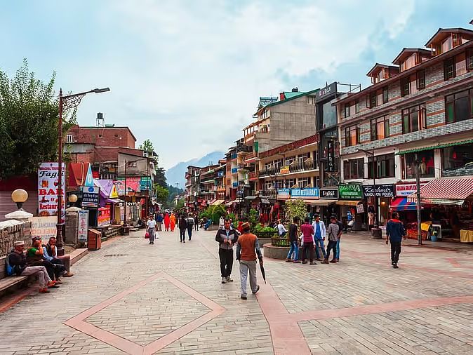 An image of a Shopping street with people bustling and building in the background