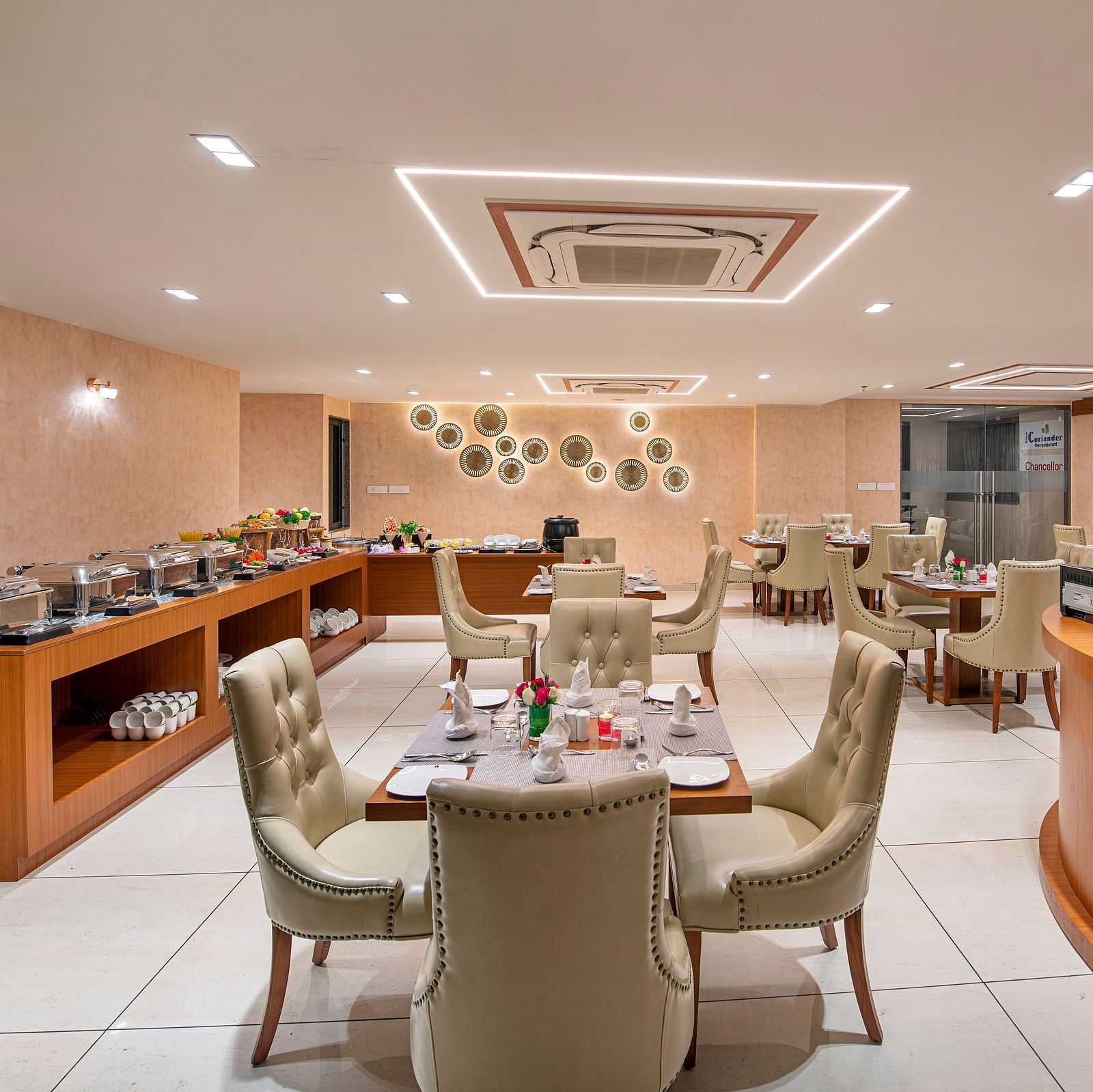 A hotel buffet area with food warmers and serving stations, ready for guests - SK Lords Inn Ahmedabad