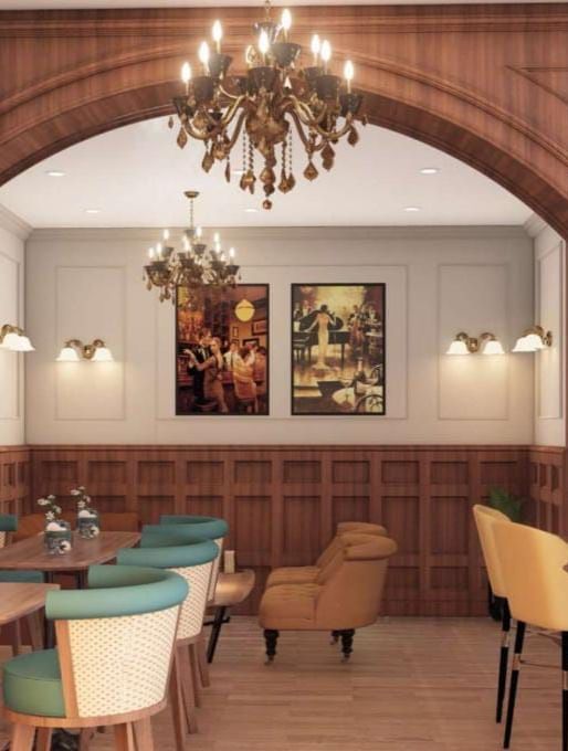 Elegant restaurant or hotel dining area featuring dark wood panelling, an arched doorway, and teal and mustard seating at BluSalzz Terrah Hills Resort, Dalhousie.