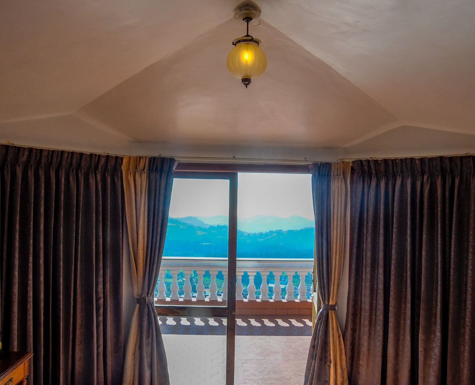 a view of the green valley of Ooty from the room at La Montana By TGI